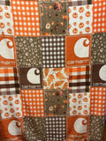 Patchwork print featuring Carhartt fabric squares in orange, brown, white, and gray, with gingham, floral, and leaf patterns.