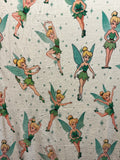 Plush blanket featuring Disney's Tinker Bell characters in green and yellow, set against a light cream background with small green stars.