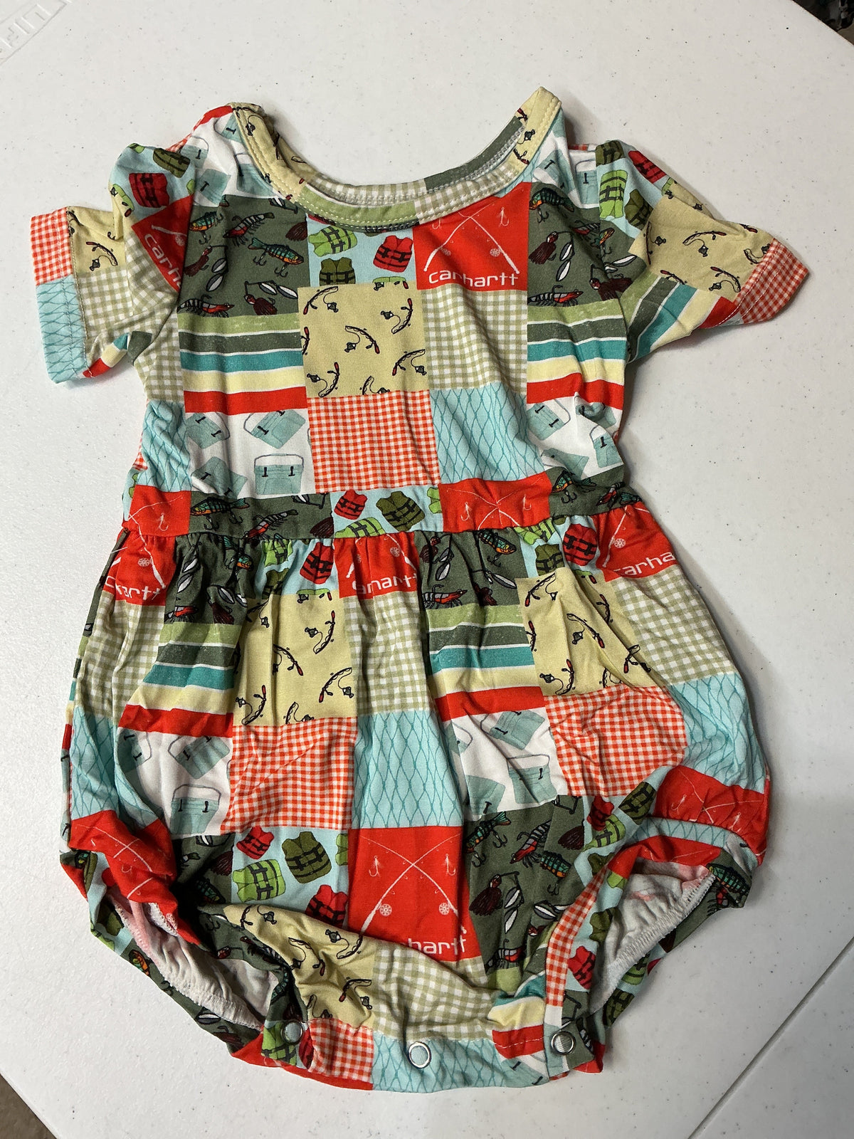 A patchwork baby romper with short sleeves and a crew neckline, featuring a colorful grid pattern of red gingham, light blue and green  prints, and beige gingham squares.